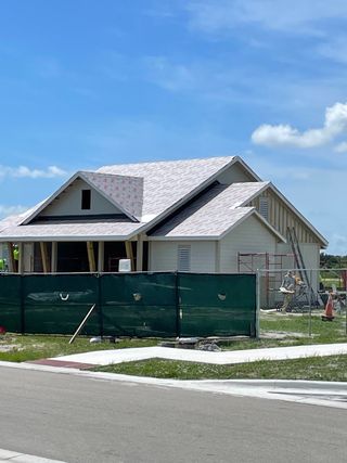 Street view A modern home under construction in Veranda Oaks by Taylor Morrison (Port St. Lucie, FL).