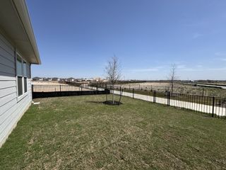 Model Home A serene view of the expansive landscape in Lakeside Meadows by Meritage Homes, Pflugerville, TX, featuring a spacious yard.