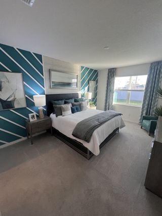 A luxurious primary suite with a dramatic feature wall, soft lighting, and a cozy yet stylish ambiance.