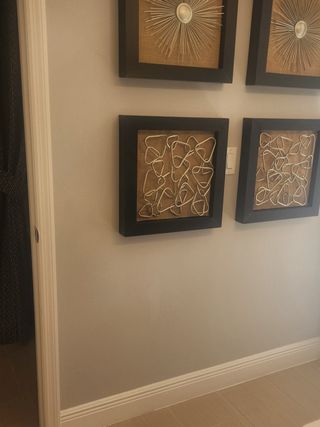 Stylish hallway featuring artistic wall decor with geometric frames and modern design elements.