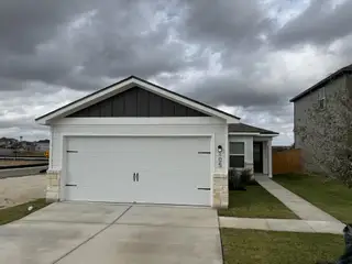 Model Home A charming modern home with a pristine white facade in Cool Water at Sonterra by LGI Homes (Jarrell, TX).