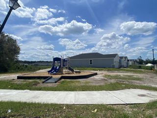 A community playground with blue slides in Cypress Meadows - Signature Series by Meritage Homes in Jacksonville, FL.