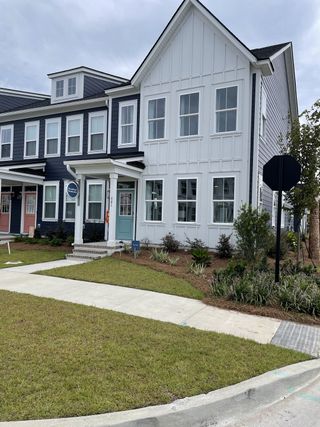 Street view A modern townhouse with contrasting navy and white siding in Townhomes at Nexton by Brookfield Residential (Summerville, SC).