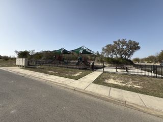 A scenic playground with shaded structures in Ladera by Coventry Homes, San Antonio, TX, offering family-friendly amenities.
