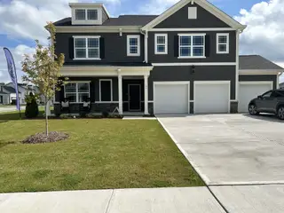 Street view A beautiful dark-toned home with a spacious driveway in Elizabeth Springs by ExperienceOne Homes, LLC (Wake Forest, NC).