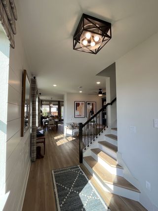 A cozy living room with stylish furniture, warm tones, and large windows in Solterra by David Weekley Homes (Mesquite, TX).