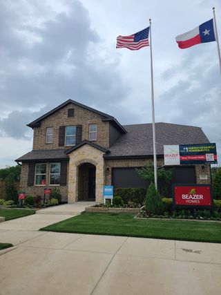 Street view A charming brick home with an elegant archway and neat landscaping in Whitewing Trails: Meadows 50' by Beazer Homes (Princeton, TX).