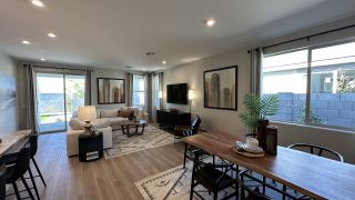 Model Home A cozy living and dining area with modern decor, neutral tones, and large windows that let in natural light.