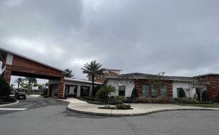 Community Amenities The Mirada Active Adult clubhouse with modern architecture and lush landscaping, a central gathering point for residents (San Antonio, FL).