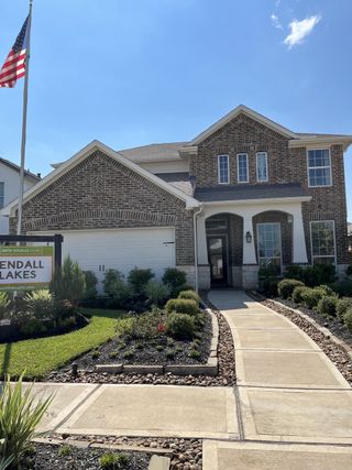 Street view A beautiful brick home with a manicured garden in Kendall Lakes by Smith Douglas Homes (Alvin, TX).