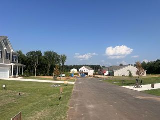 Street view New development with modern homes and landscaped yards in Saddlebrook by Smith Douglas Homes (Sherrills Ford, NC).