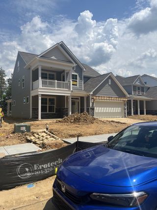 Street view A modern gray two-story home under construction in Hampton Woods by Eastwood Homes (Charlotte, NC).
