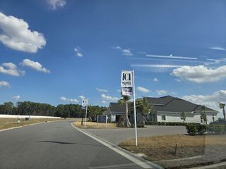 A modern home with a paved driveway and palm trees in the Tidewater community by ICI Homes, Jacksonville, FL.