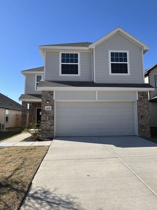 A modern two-story home with a spacious driveway in Hanna Ranch by Legend Homes (Fort Worth, TX).