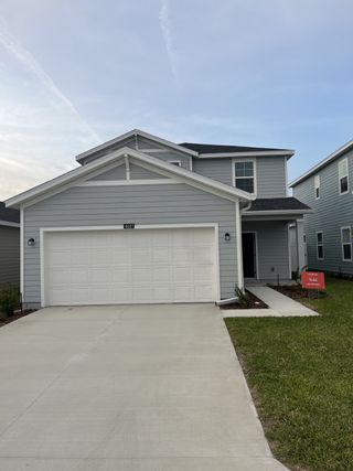 A modern gray two-story home with a spacious driveway in Marion Ranch: Marion Ranch 40's by Lennar (Ocala, FL).