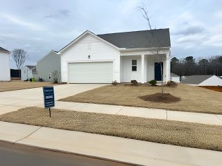 A modern white home with a two-car garage and a neat yard in Bryson's Ridge by Starlight Homes (Spring Hope, NC).