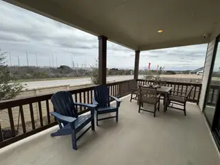 A spacious patio with comfortable seating and a dining area, perfect for relaxation and entertaining.
