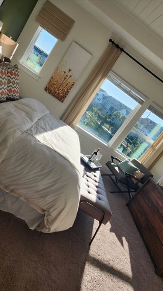 A sleek bathroom with a striped shower curtain, bright vanity, and elegant tile flooring for a fresh and clean look.