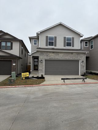 Street view A charming home with modern stone accents, welcoming you to Cove at Westover Hills in San Antonio, built by KB Home.