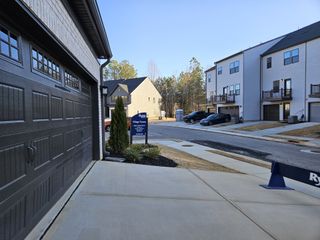 Street view Modern townhomes with spacious garages in Village Towns by Ryan Homes, located in Fayetteville, GA.