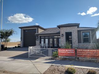 A modern home with stone accents and a sleek garage in Seasons at Rio Rancho by Richmond American Homes (Surprise, AZ).