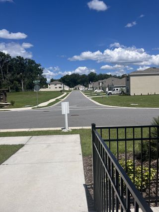A picturesque street view in Autumn Glen by D.R. Horton, featuring modern homes and a serene suburban landscape (Belleview, FL).