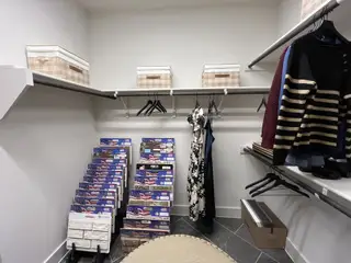 Model Home A well-organized pantry with white shelving and stylish storage solutions in Solterra by David Weekley Homes (Mesquite, TX).