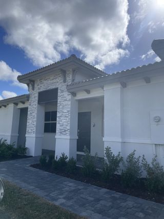 Street view A contemporary home with stone accents and lush landscaping in Silverland Estates by Lennar (Miami, FL).