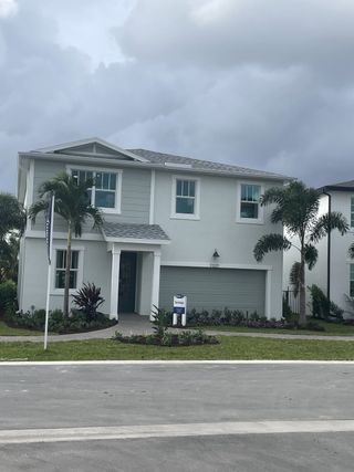 A modern two-story home with a manicured lawn in Forest – Townhomes by Mattamy Homes (Lake Worth, FL).