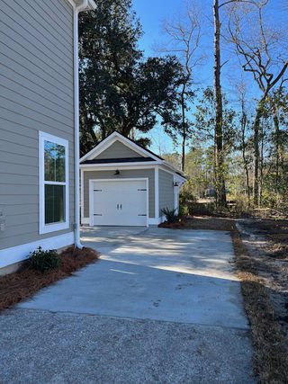 A modern garage with a sleek driveway and charming facade in Pineland Village by Center Park Homes (Summerville, SC).