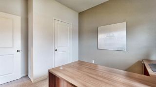 Model Home A modern office space with a sleek wooden desk, neutral walls, and minimalist decor.