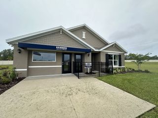 A charming, modern home with crisp exterior finishes and a well-maintained lawn in Huntington Ridge by D.R. Horton (Ocala, FL).
