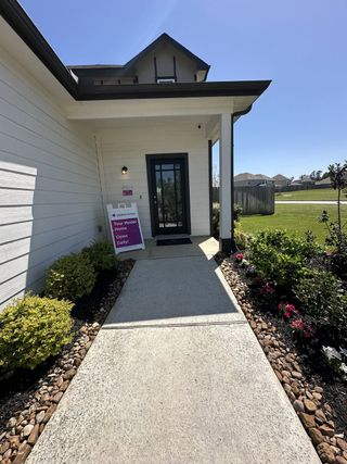 A charming home with inviting landscaping in River's Edge by Legend Homes (Conroe, TX).
