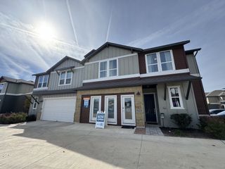 Modern townhome at The Poppy at Vista Vera by Homes by Avi (Georgetown, TX) boasts a stylish facade, perfect for new beginnings.