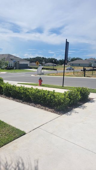 Street view A scenic street view with modern homes in Seaport Village by Dream Finders Homes, Tavares, FL.