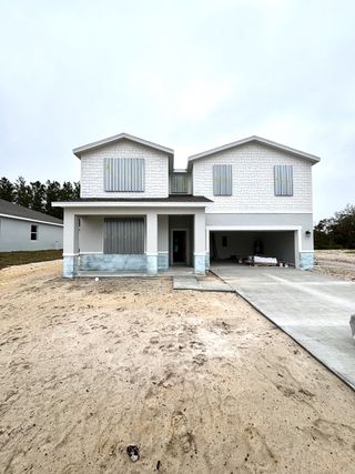 A modern white home with dual gables and a covered entry in Brookshire by Stanley Martin Homes (Titusville, FL).