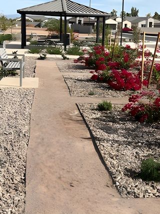 A scenic path with lush landscaping and a modern gazebo in Edgewood Estates by K. Hovnanian® Homes (Queen Creek, AZ).