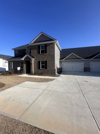 A modern brick-front home with a spacious driveway in Independence by D.R. Horton (Loganville, GA).