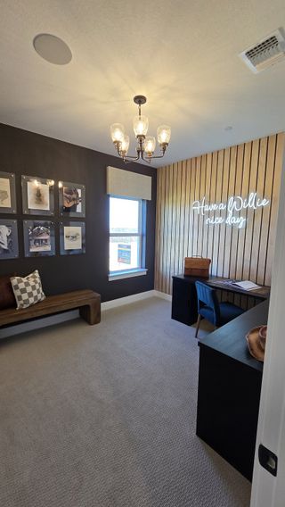 A cozy office space with wood accent wall, stylish desk, and warm lighting, perfect for productivity and inspiration.