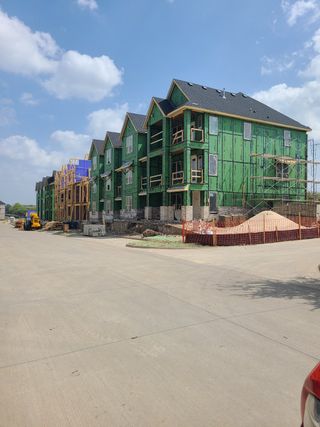 Modern multi-story homes under construction in Wade Settlement by Megatel Homes, Frisco, TX, showcasing future community growth.