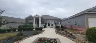 A charming brick home with stone accents and lush landscaping in Sage Meadows by Lennar (St. Hedwig, TX).