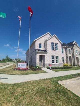 A charming brick home with a manicured lawn in Twin Creeks Watters by CB JENI Homes (Allen, TX).