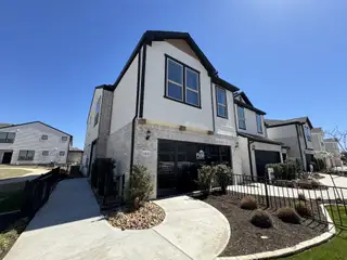 Street view A stunning modern home with a sleek black-and-white exterior in Whitestone Preserve by Pulte Homes (Cedar Park, TX).
