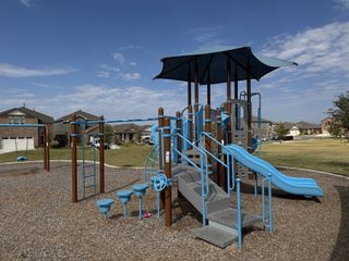 Community Amenities A vibrant playground with slides and swings in Firefly Pointe: Stonehill Collection by Lennar, Hutto, TX.