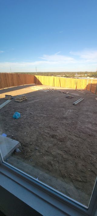 Model Home A spacious backyard with a wooden fence in Landon Ridge by Lennar (San Antonio, TX).