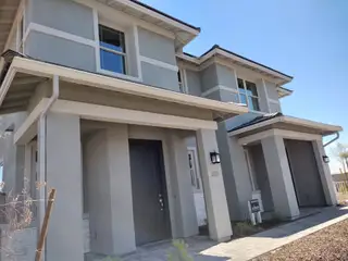 Street view A modern gray home with sleek lines and a welcoming entry in Heritage at Verrado by Richmond American Homes (Buckeye, AZ).