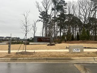 The entrance to Twyla Walk, showcasing a modern community sign and landscaped surroundings by Stanley Martin Homes (Cary, NC).