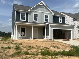A modern two-story home with a covered porch in Piper Landing by M/I Homes (Concord, NC).