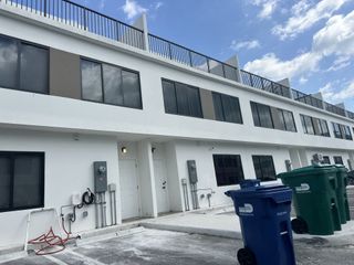 Street view Modern white building with large windows in On Grandville by Onx Homes (Homestead, FL).