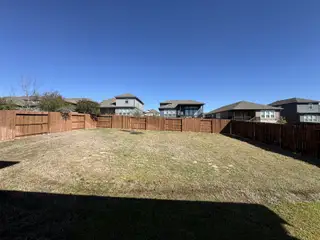 Expansive fenced backyard in Homestead by CastleRock Communities, ideal for family fun, in Schertz, TX.